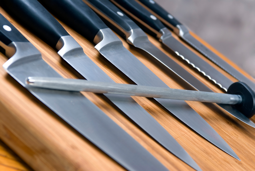 A set of high quality kitchen knives on a cutting board