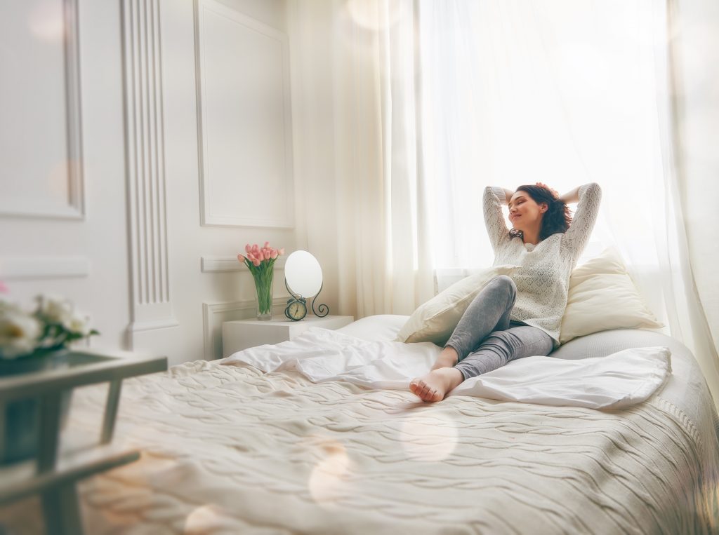 Young Woman Relaxing in Her Dream Bedroom