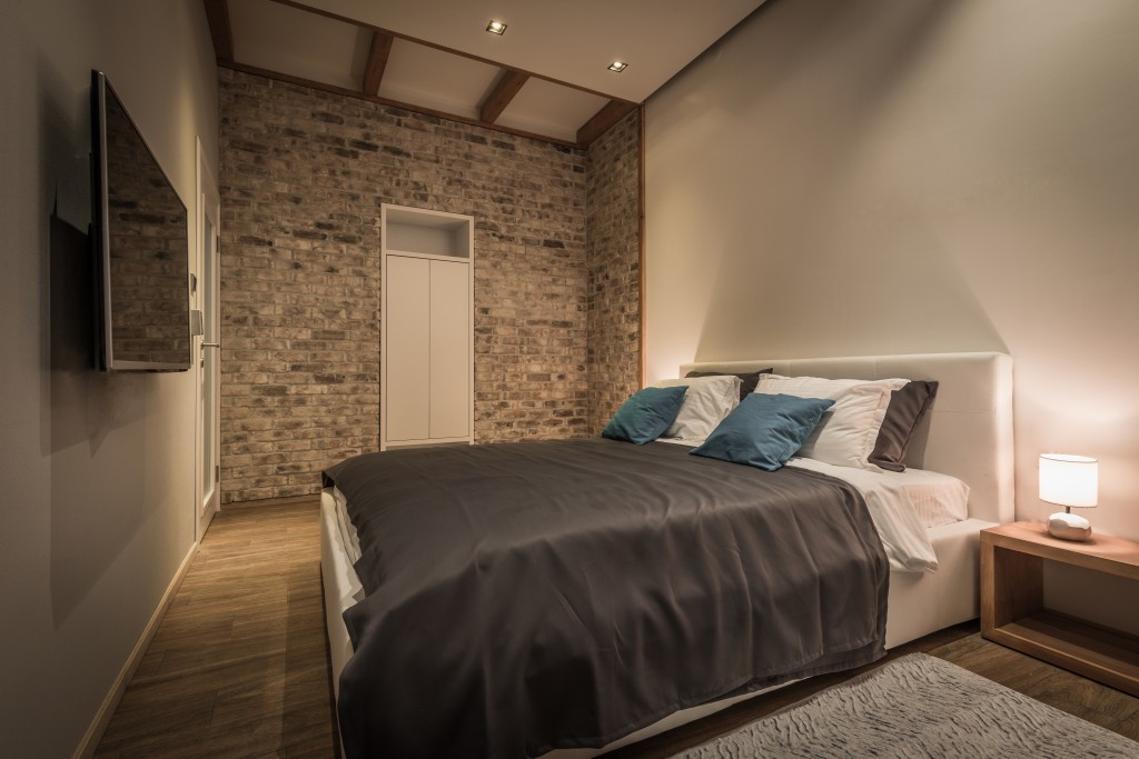 Retro designed bedroom with brick wall