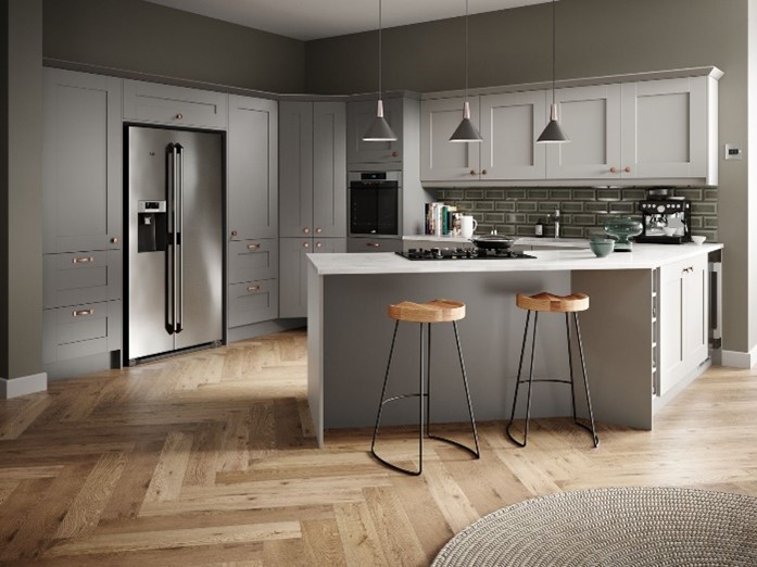 A grey kitchen with kitchen island and a wood floor