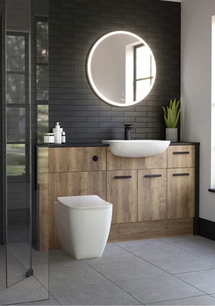 A bathroom with a round mirror