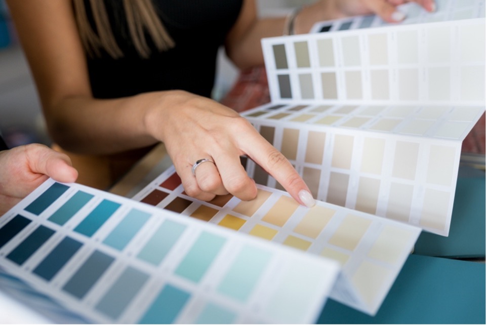 A person pointing at a colour swatch